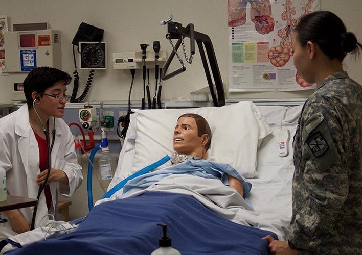 Students practicing with an anthropomorphic test device